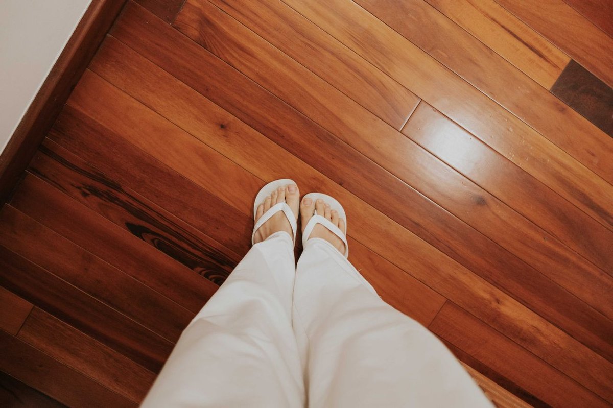 woman looking down on the floor and her feet