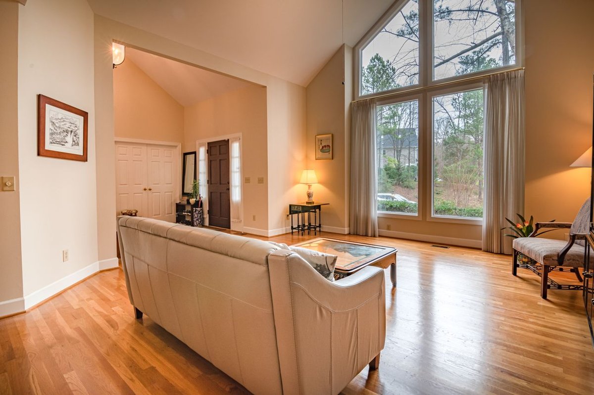 Bright and cozy living room with modern decor and large windows.
