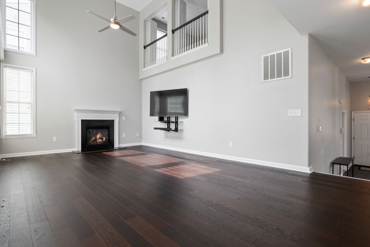 Bright and modern living room featuring a fireplace and mounted TV, perfect for contemporary homes.