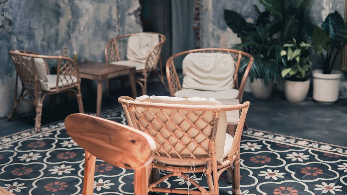 Rustic wicker furniture arrangement in an outdoor Indonesian cafe setting, ideal for relaxation