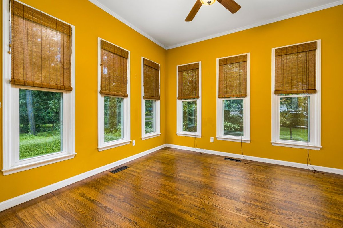 wooden window blinds in a yellow room