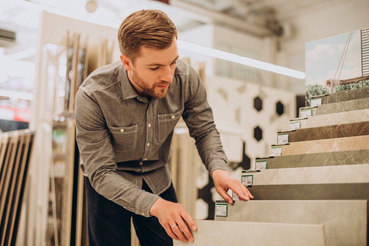 A man choosing flooring samples at a flooring store
