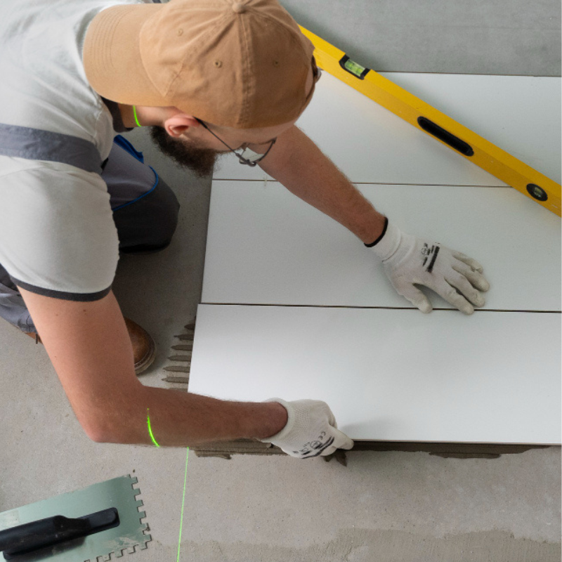Tiler working on renovation of apartment