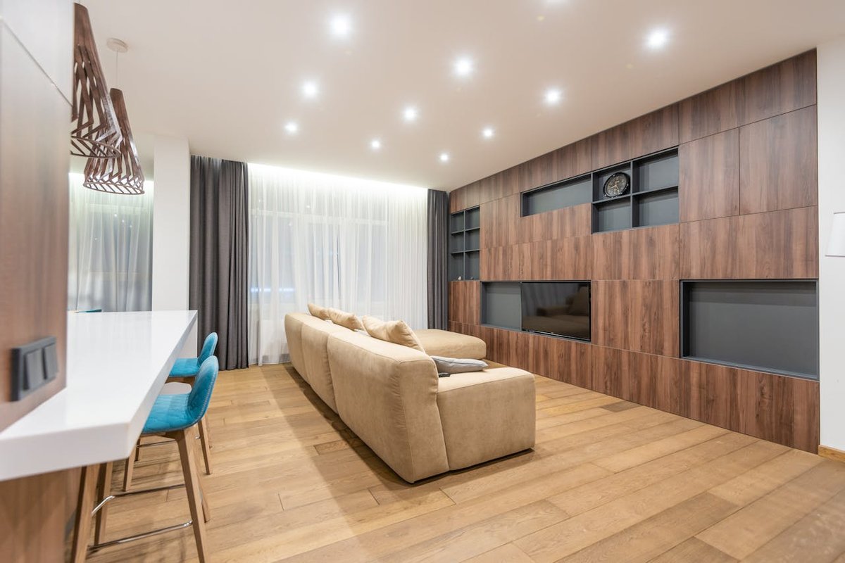 A stylish and spacious living room with modern furniture and warm lighting.